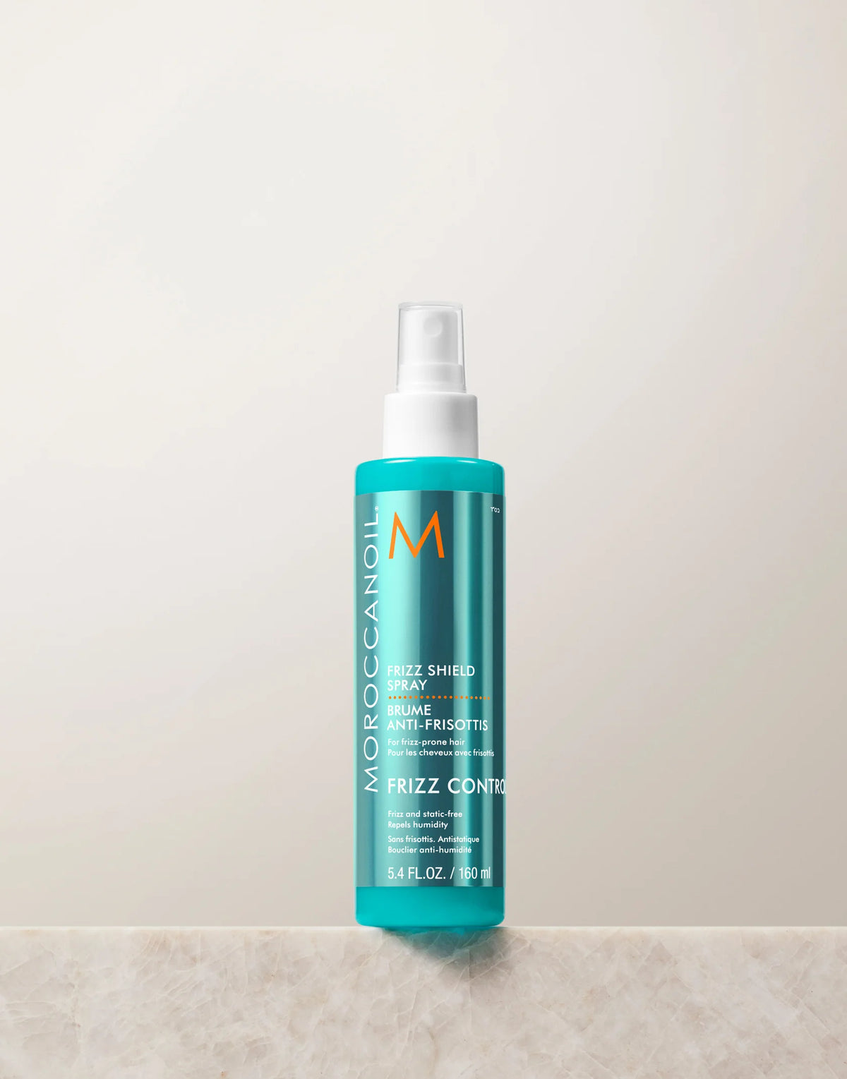 Turquoise Moroccanoil Frizz Shield Spray 160 ml bottle with white spray nozzle