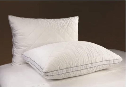 Diamond Gusset Pillow with gel fiber fill and pinsonic quilted cover on a bed.