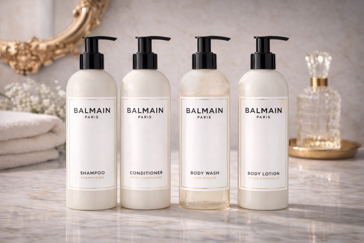 Balmain Paris Luxury Bath& Body Set featuring shampoo, conditioner, body wash, and body lotion on a marble surface.