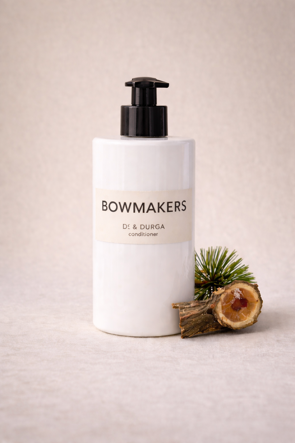 D.S. & Durga Bowmakers Conditioner bottle with typography and natural elements on a soft background.