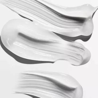 Close-up of smooth, glossy white styling serum swatches on a white background.