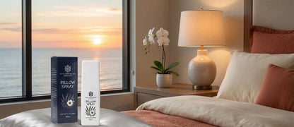 Pillow spray bottles on a bed with a scenic window view.