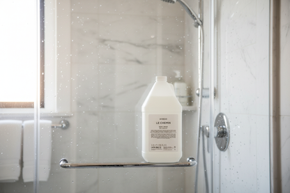 Byredo Le Chemin Body Wash in elegant glass shower with water droplets