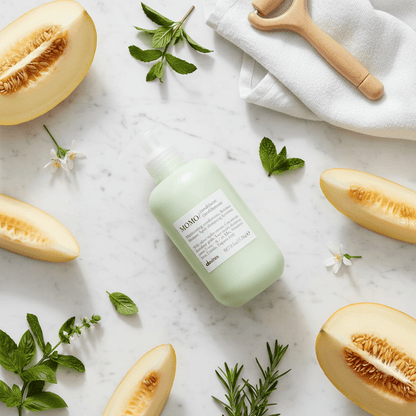Davines MOMO Conditioner flat lay with fresh melon and Italian spa elements
