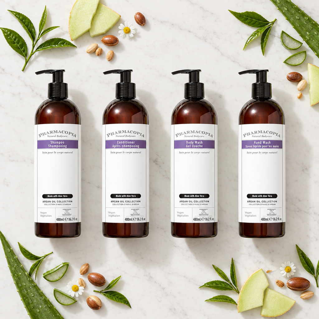 Pharmacopia Argan Oil shampoo, conditioner, body wash and hand wash four-piece flat lay with botanical accents
