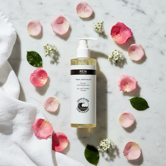 REN Rosa Centifolia Facial Cleansing Gel flat lay with rose petals on white marble