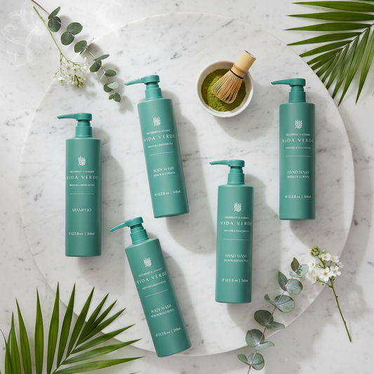 Vida Verde Complete Collection - all 5 pieces (shampoo, conditioner, body wash, hand wash, body lotion) on marble flat lay with botanical leaves