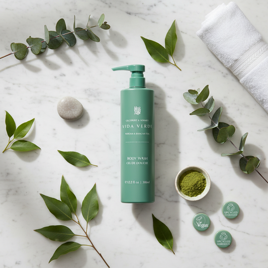 Vida Verde Body Wash - luxury hotel body wash on marble flat lay with fresh botanical leaves and eucalyptus