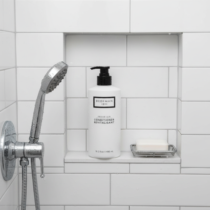 Beekman 1802 Fresh Air Conditioner overhead shot white bottle in modern shower niche white tiles - premium goat milk conditioner