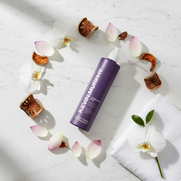 Kevin Murphy Young.Again Conditioner - circular flat lay with orchid, baobab, lotus on marble