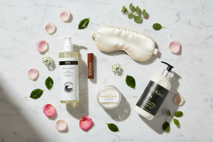 Suite Dreams luxury hotel spa self care gift set five products flat lay white marble Marriott eye mask Sahajan lip care REN facial cleansing gel Atelier Bloem eucalyptus bath salts Bee Kind lotion
