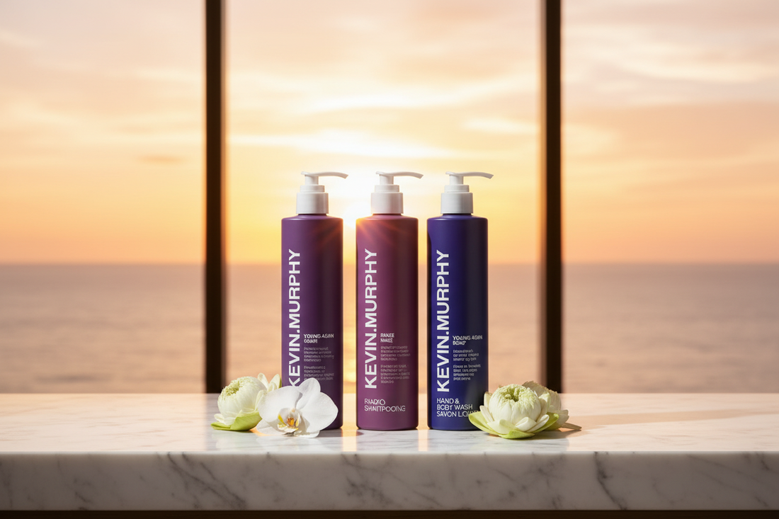 Kevin Murphy Young.Again 3-Piece Set flat lay with orchid blooms and lotus flowers on white marble — luxury hotel hair and body care bundle